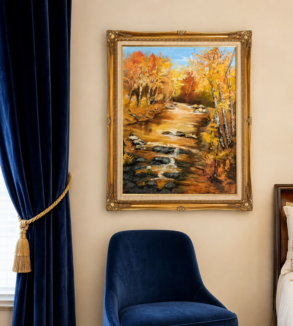 Bedroom corner with a large gold-framed autumn landscape oil painting, navy velvet curtains with gold tassel tieback, and a navy velvet accent chair