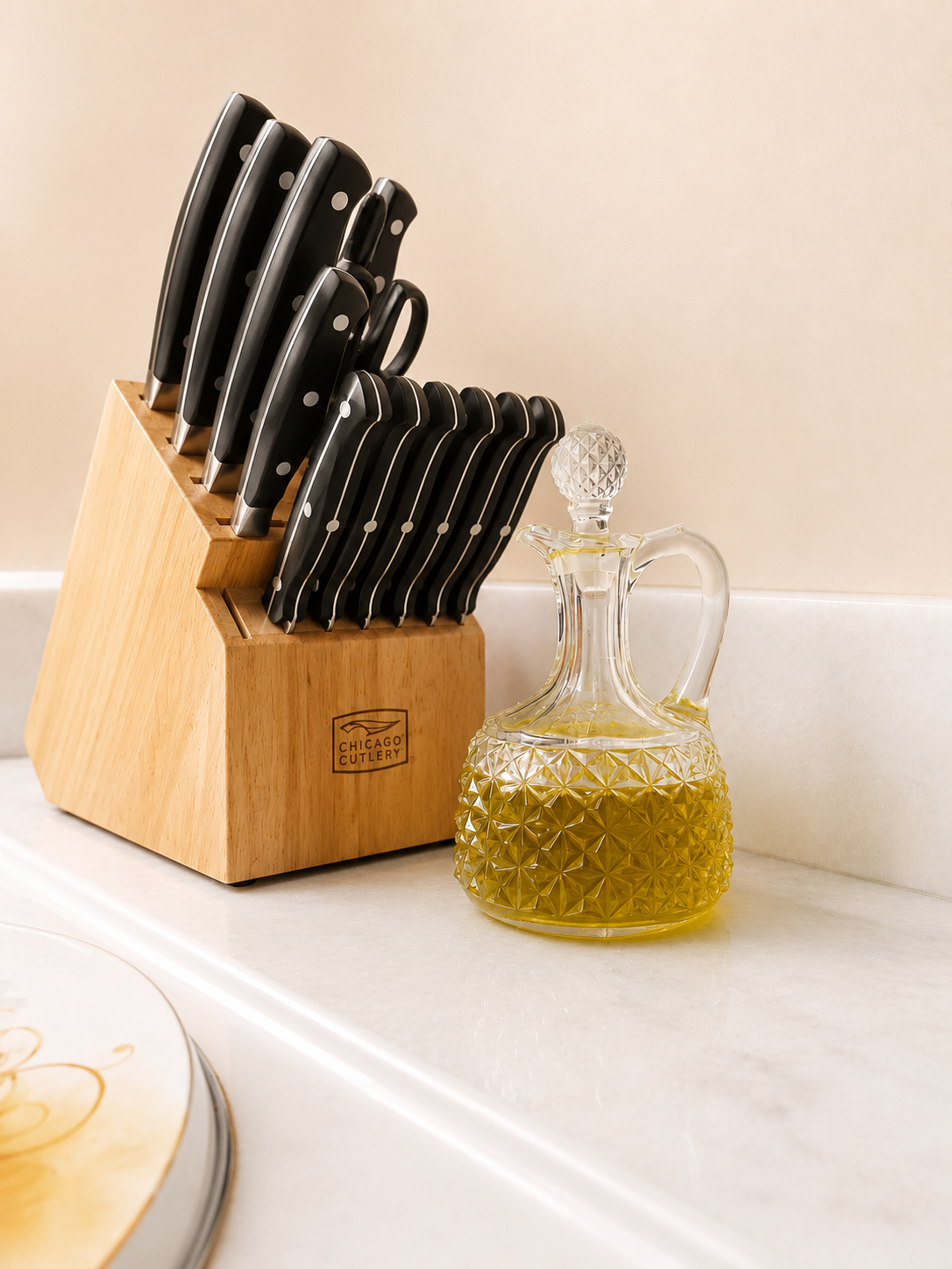 Kitchen counter with a Chicago Cutlery knife block beside a crystal glass oil decanter